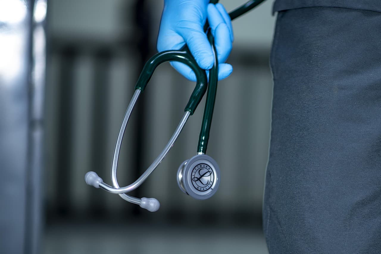 Stethoscope in gloved hand